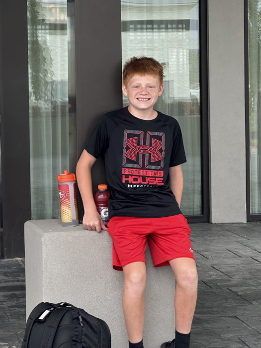 One of the kids ready to roll, backpack and Gatorade in hand outside the hotel.