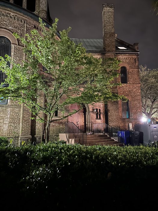 A handsome old brick building catching the streetlight on an evening stroll through Charleston.