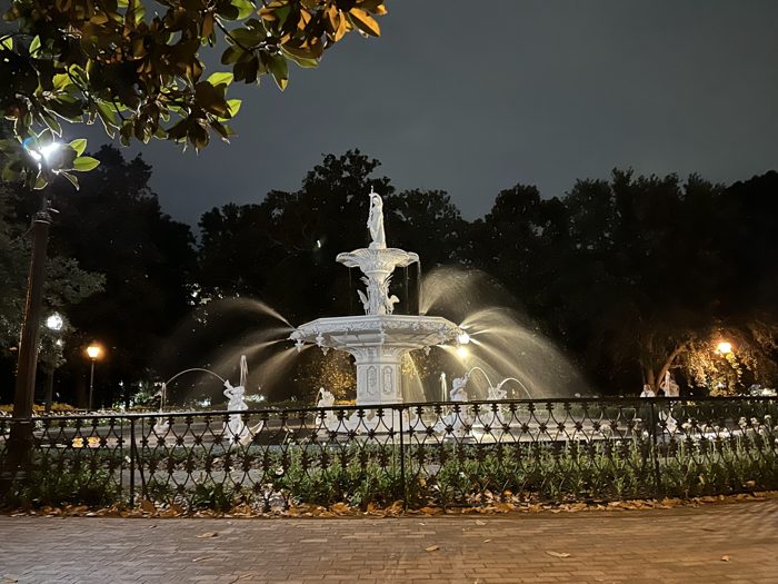Spanish moss framing the glowing Forsyth Park fountain.