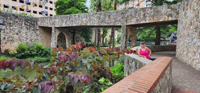 Terraced stone walls and lush plantings climbing the River Walk gardens.