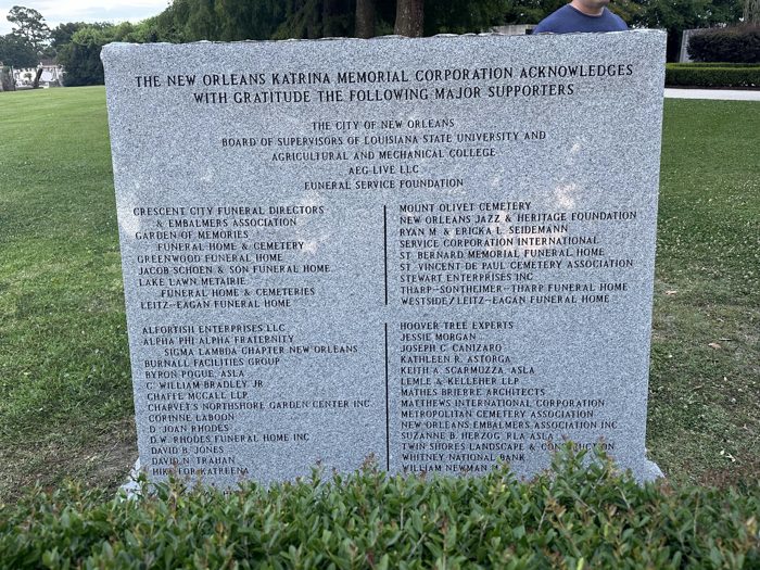 The spiraling black granite walls of the Hurricane Katrina Memorial, names etched in remembrance.