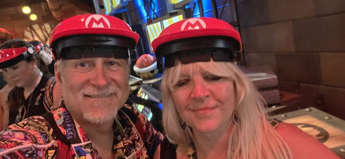 Matching Mario hats for a couple's selfie after the ride.