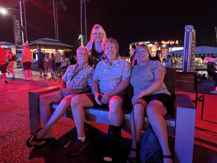 One more group shot on the bench as CityWalk buzzes with nightlife behind them.