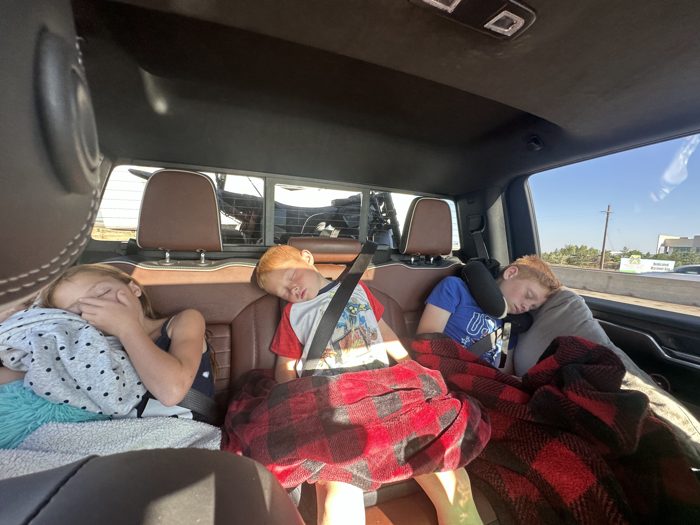 Three kids sound asleep in the back seat before we've even stopped for gas this morning.