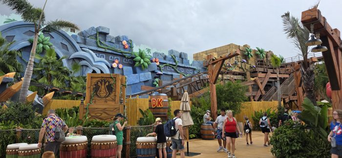 Wandering past the jungle ruins and coaster track of the theme park's Donkey Kong land.