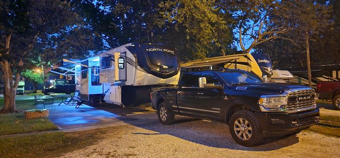Camp lit up blue at dusk on the edge of New Orleans.