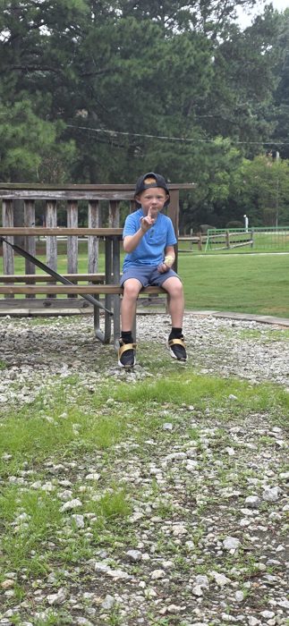 A moment later, still perched on the same bench, finger raised for one more silly pose.