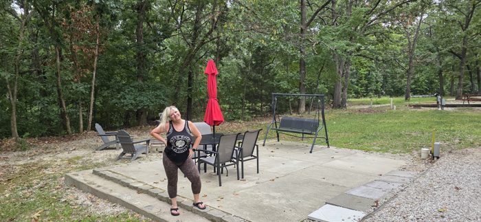 One more playful pose on the site's patio before packing up the swing and fire-ring chairs behind her.