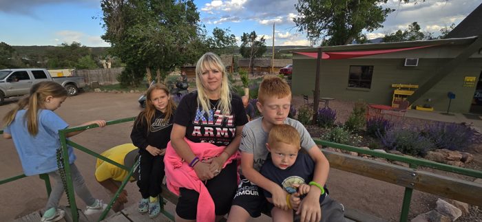 Mom and the whole crew squeezed in for a happy family photo at the park.
