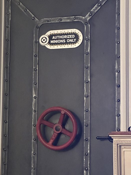 A playful Authorized Minions Only sign marks a themed doorway somewhere inside the park.