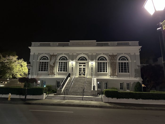The historic Unitarian Church standing floodlit in the night.