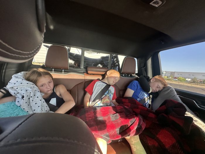 A quick rest-stop check-in at a highway truck stop while everyone else naps through it in back.