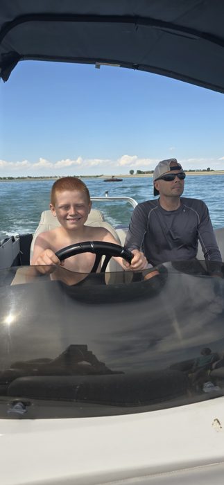 Taking the helm for a ride out on the lake.