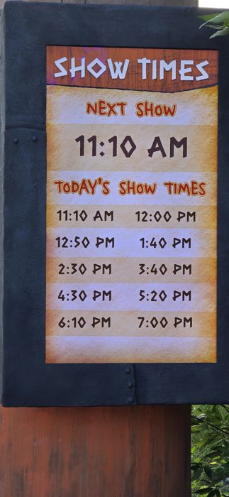 A show times board lists out today's performances at the park.