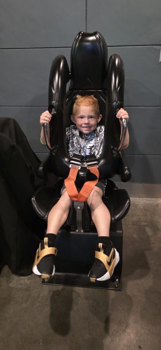 Another big grin from the same ride seat, harness clicked in tight.