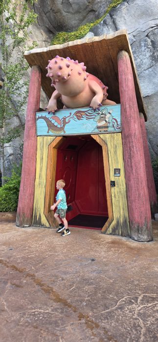 One of the kids ducks through a troll-guarded doorway on the way to the next ride.
