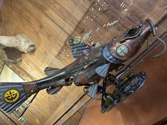 A vintage aircraft hangs overhead inside the Bass Pro Pyramid, part of its over-the-top indoor decor.