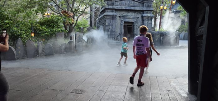 One of the kids in a monster-movie t-shirt strolls into the mist with the rest of the group.