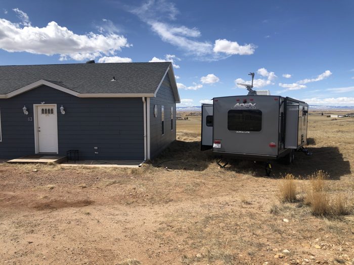 Our trailer parked right alongside the little blue house on the Wyoming prairie.