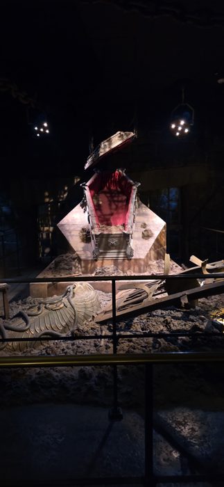 An eerie open coffin lit up inside one of the park's dark attractions.