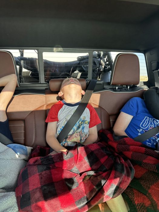 Still crashed out in the back seat as the morning miles roll by.