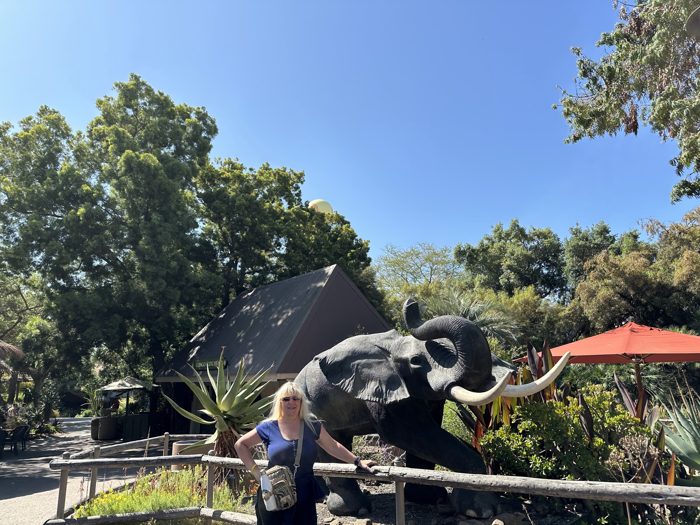 Posing for a photo beside the towering elephant statue at the Safari Park.