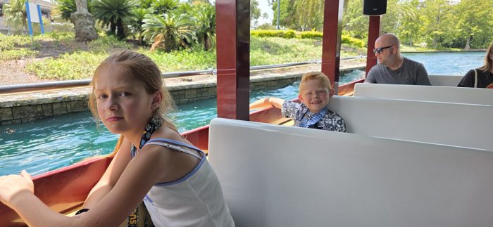 A quieter moment on the boat as the kids soak in the resort lagoon scenery.