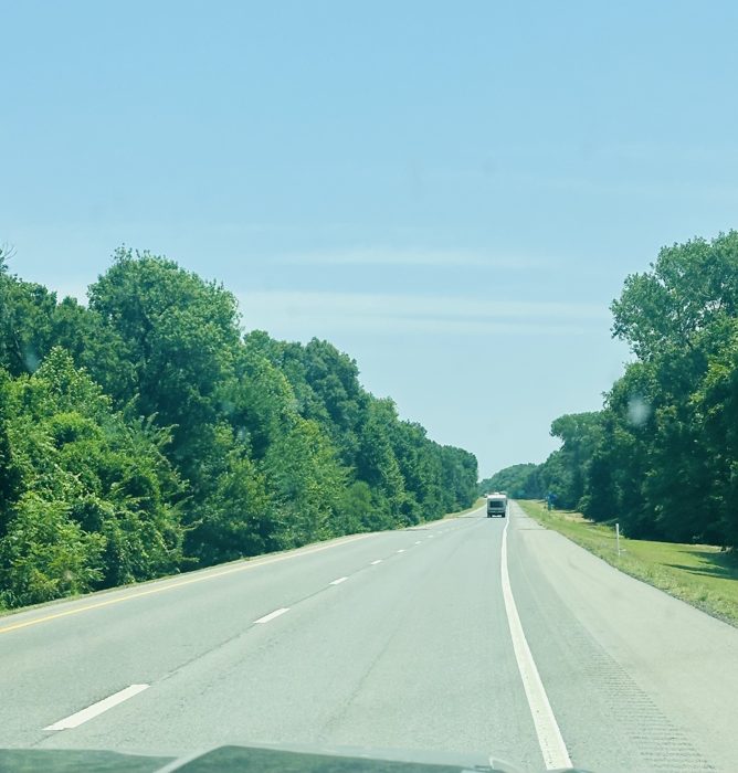 Miles of open highway with another RV up ahead making its way along the same route.