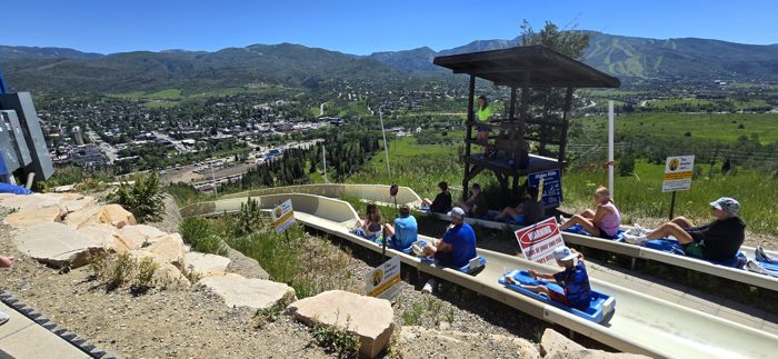 Riding the alpine slide down the hillside with Steamboat town stretching out below.