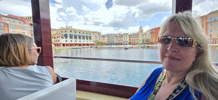 Riding the water taxi past the resort's colorful waterfront buildings.