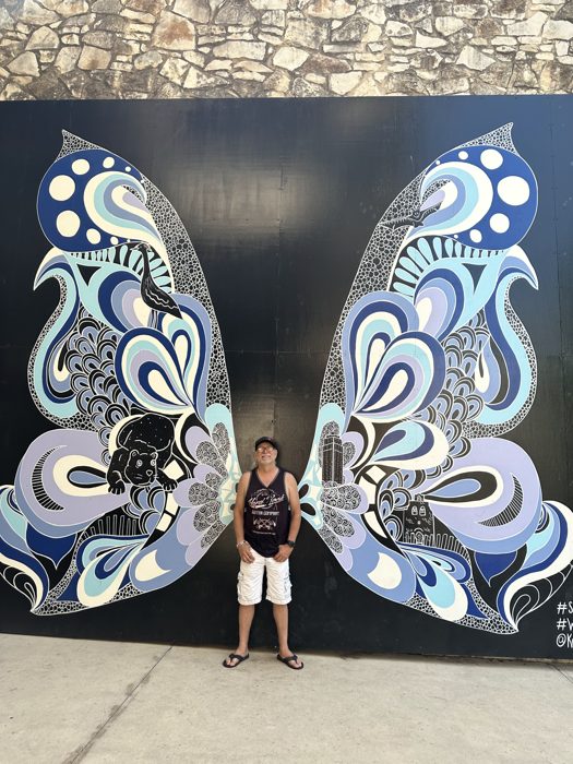 Posing in front of San Antonio's iconic giant butterfly mural.