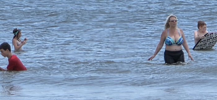 The family scattered through the waves, boogie boards in hand.