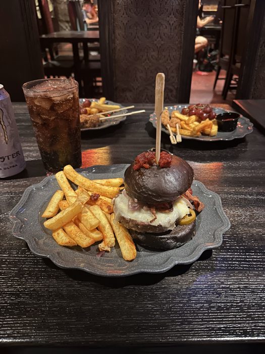 Digging into burgers, fries, and shared appetizers around the table at dinner.
