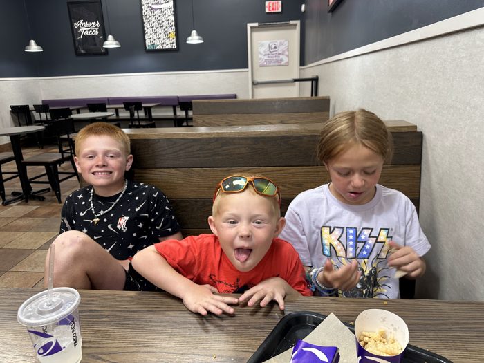 The kids crowded together at the counter, all smiles before heading back out on the road.