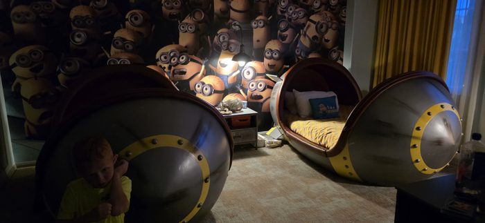 One of the kids lingers by the glowing Minion pod beds before lights-out.