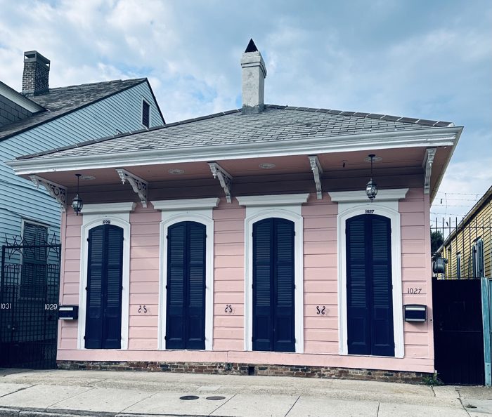 A classic French Quarter facade with its pale shutters and arched windows, exactly the New Orleans look you picture.