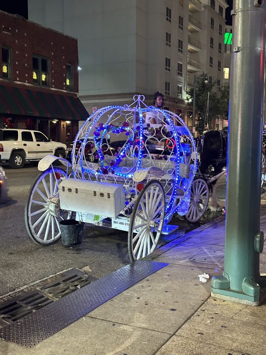 A glowing fairy-tale carriage all lit up against the Beale Street night.