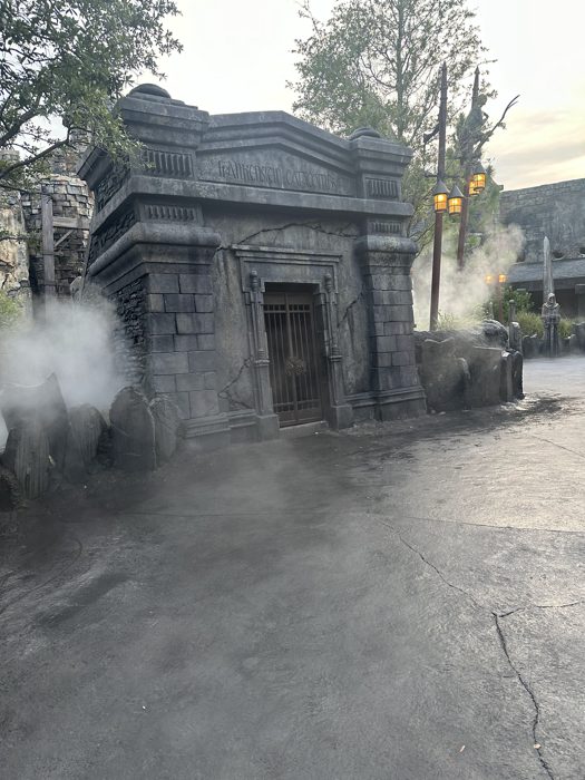 A ghostly robed statue watches over the misty courtyard outside the Catacombs.