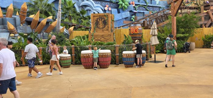 One of the kids stretches up onto a giant drum in the jungle-themed play area.