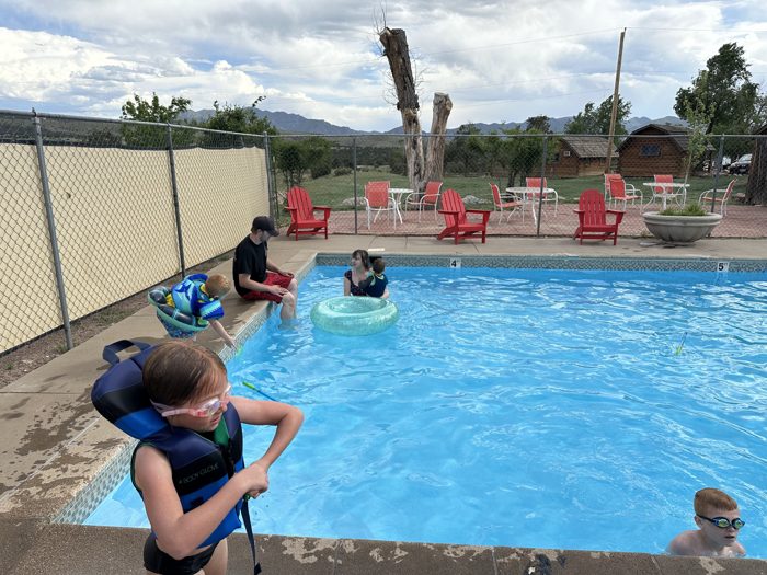 The kids splashing and floating in the Amarillo KOA pool on a warm afternoon.