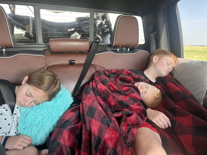 The kids catch a little more sleep as the rig rolls past open farmland this morning.