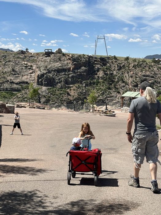 Hauling the kids in the wagon down the dusty path with the gorge bridge waiting up ahead.