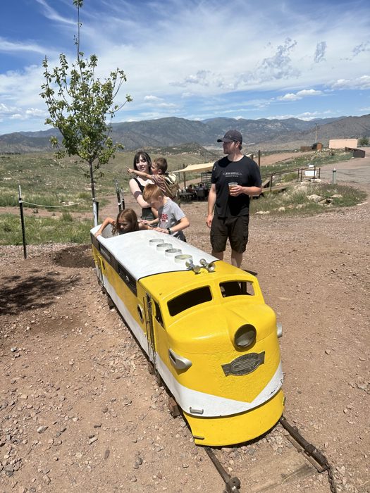 All aboard the cheerful yellow mini-train at the park's kids' play area.