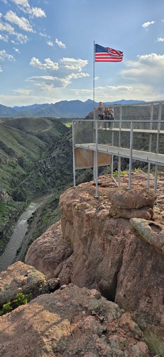 The American flag snapping in the wind high above the Royal Gorge.